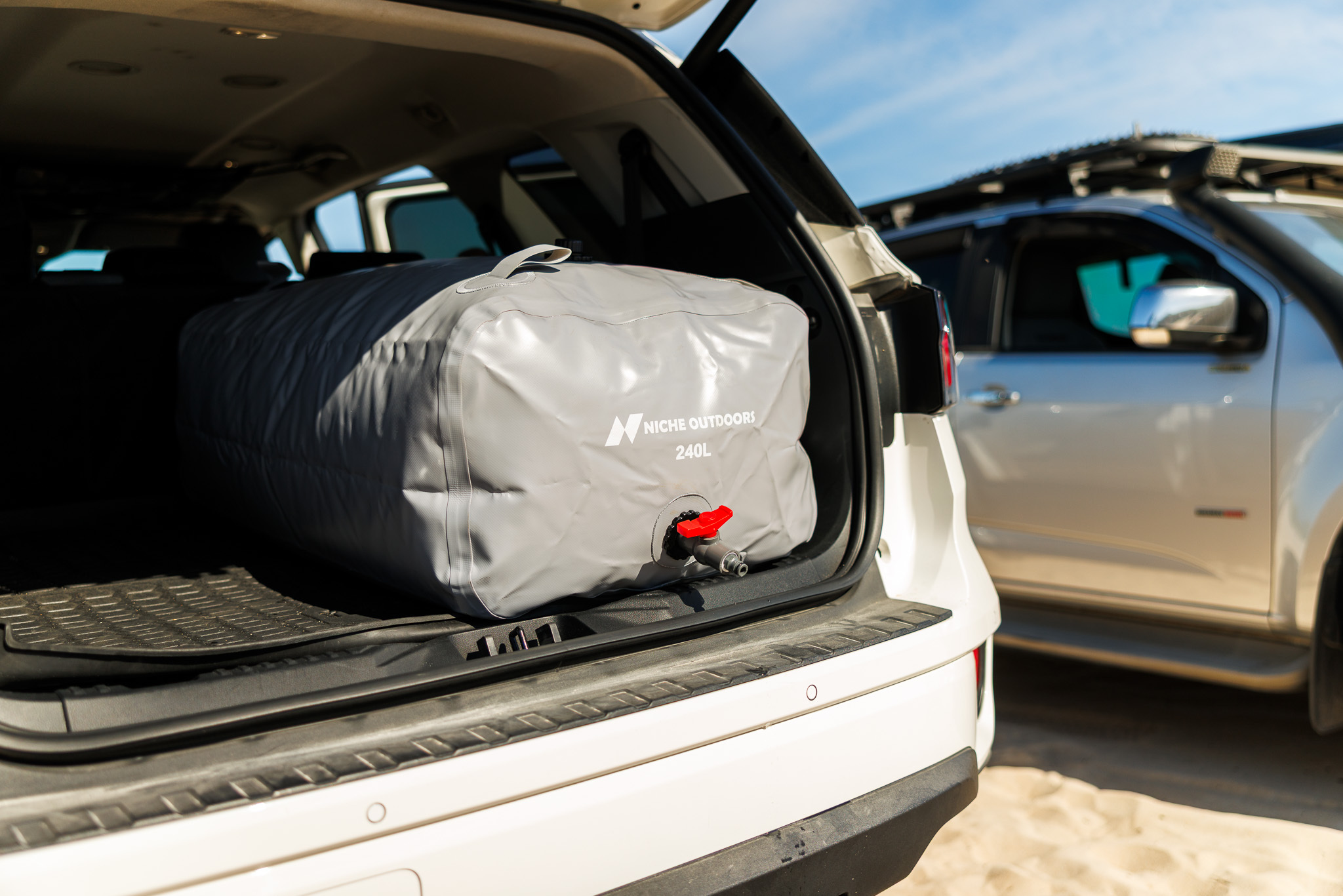 Niche Outdoors 240L Wide water bladder positioned in a vehicle cargo area