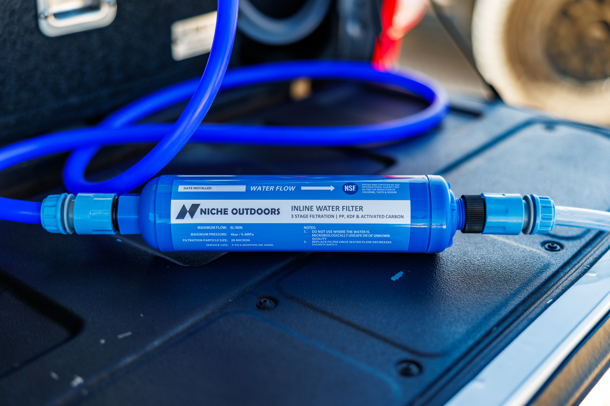 Niche Outdoors inline water filter connected to a camping water setup